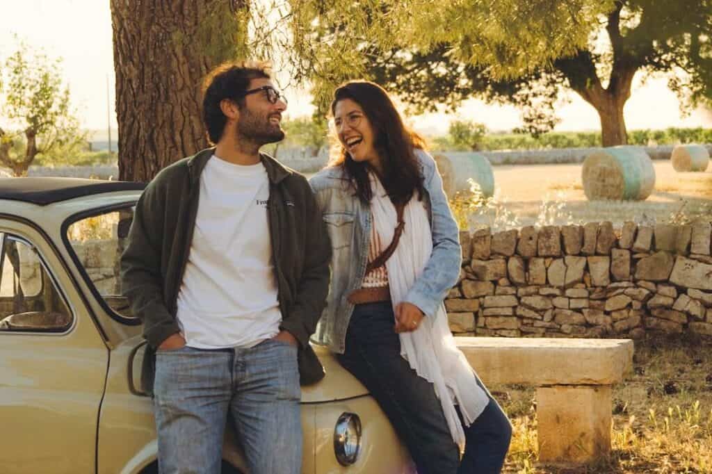 Coliving residents enjoying a relaxed moment outdoors in the countryside of Italy