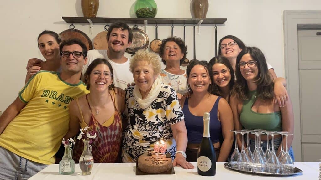 Digital nomads enjoying a communal dinner at a rural coliving in Italy at Masseria Olga