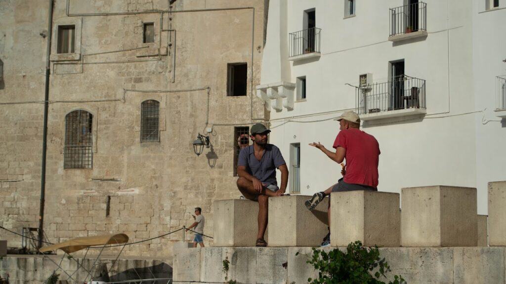 Digital nomads connecting in a historical town near Masseria Olga during the coliving experience in Puglia, Italy.
