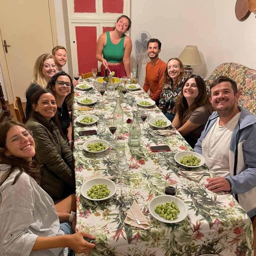 Digital nomads sharing a communal dinner at Masseria Olga coliving in Italy