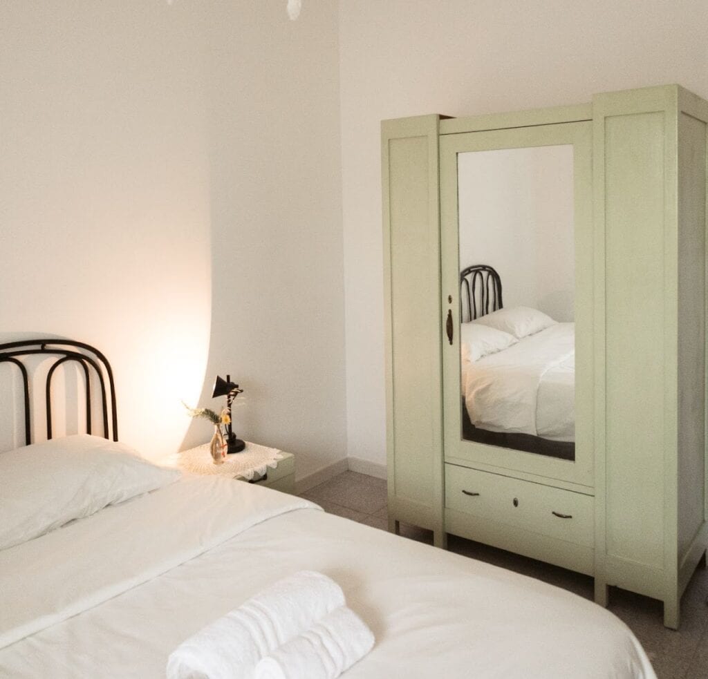 Cozy private room with mirror wardrobe at Masseria Olga, rural coliving in Italy