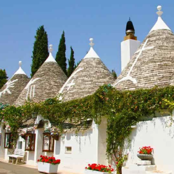 Aerial view of Alberobello with traditional trulli houses near Masseria Olga coliving in Puglia, Italy.