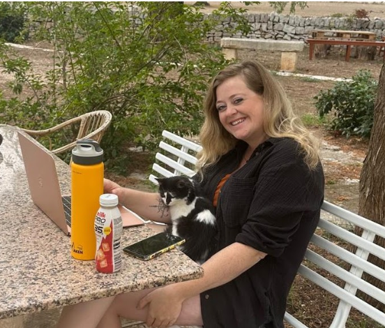 Digital nomad Rachel working remotely and pet-sitting a cat at Masseria Olga in Puglia, Italy